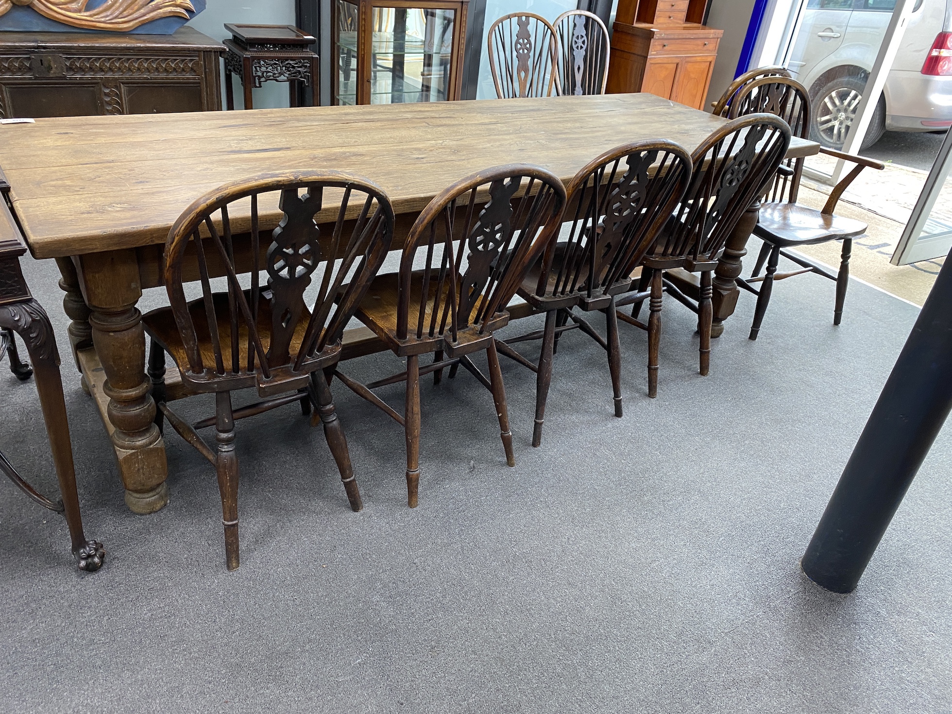 A harlequin set of ten 19th century ash and elm Windsor wheelback dining chairs, two with arms